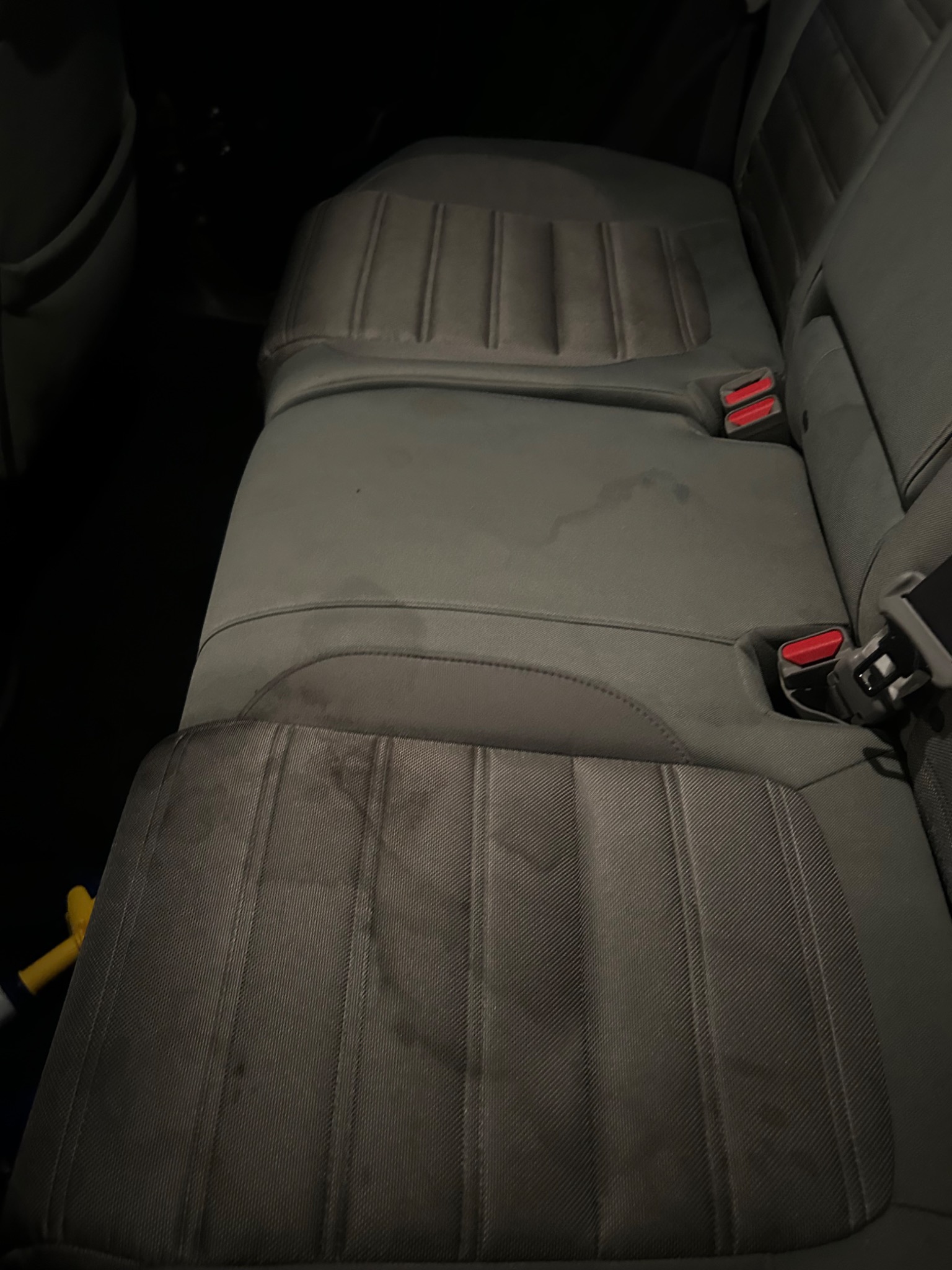 Stained rear seat before interior cleaning